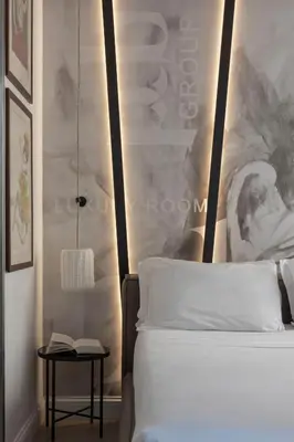 a bedroom with a white bed and a side table at BDB Rooms Navona in Rome