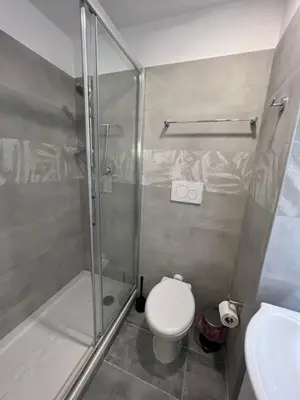 a bathroom with a shower and a toilet and a sink at Favola Romana - Guest House in Rome