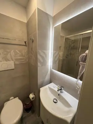 a bathroom with a sink and a toilet and a mirror at Favola Romana - Guest House in Rome