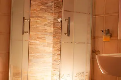 a shower with a glass door in a bathroom at Ninuphar Maison - alloggio per uso turistico in Rome