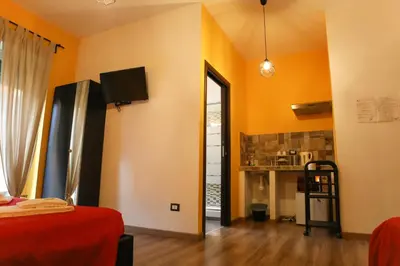 a room with orange walls and a room with a bed at Nonna's house in Rome