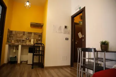 a room with a table and chairs and a door at Nonna's house in Rome