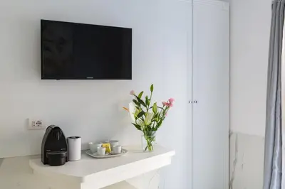 a living room with a tv on a white wall at Little Aurelius in Rome