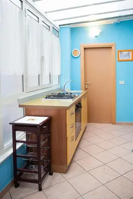 a kitchen with a stove and a sink and a door at La Dolce Vita Colosseum in Rome