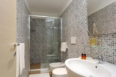 a bathroom with a shower and a sink and a toilet at AdoraSuite 2 in Rome