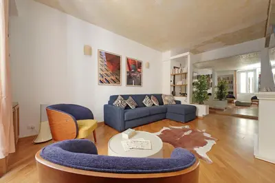 a living room with a blue couch and chairs at Casa Navona - My Extra Home in Rome