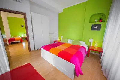 a bedroom with a colorful bed in a room at Da Paolo al Vaticano in Rome
