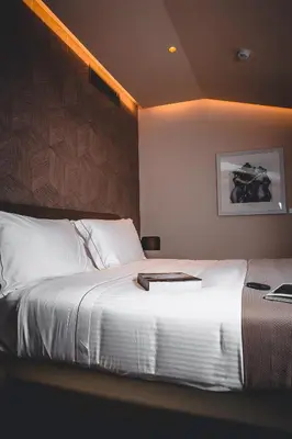 a hotel room with a large bed with a white bedspread at Margutta 19 - Small Luxury Hotels of the World in Rome