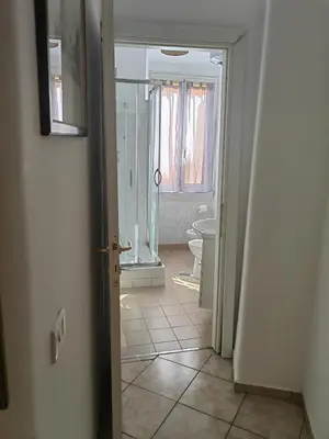 an open door to a bathroom with a toilet at Roman Holidays in Rome