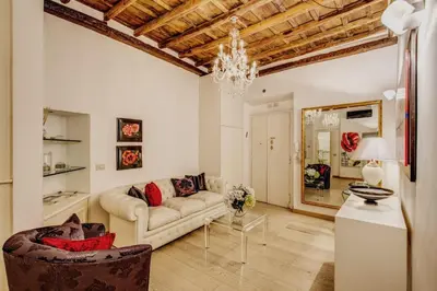 a living room with a couch and flowers on a table at Portico D'ottavia in Rome