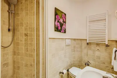 a bathroom with a sink and a shower at Portico D'ottavia in Rome