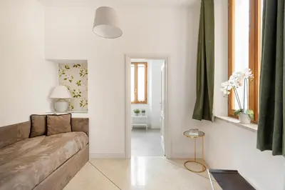 a living room with a couch and a table at i Fiori de' Mario Suites in Rome