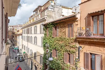 an ivy covered building on a city street at i Fiori de' Mario Suites in Rome