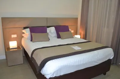 a bedroom with a large bed with purple pillows at Bloom Apartment in Rome