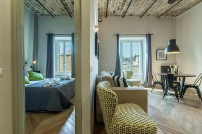 a bedroom with a bed and a tub in a room at EVE Penthouse Colosseo in Rome