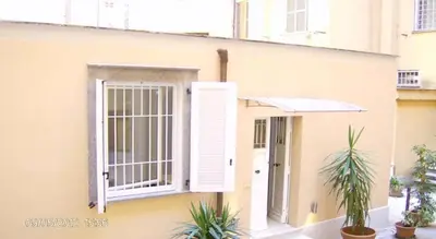 a building with an open window and an umbrella at Parioli House near Borghese-LUISS University in Rome