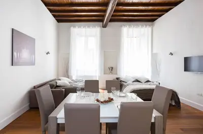 a dining room with a white table and chairs at Campo Marzio Boutique in Rome