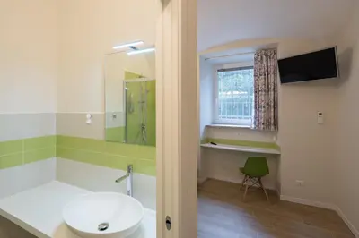 a bathroom with a sink and a tub and a mirror at Bed&BikeRome ROOMS in Rome