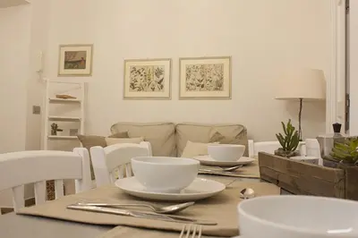 a dining room table with bowls and plates on it at Splendid House In Trastevere in Rome