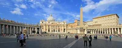 a group of people walking in front of a large building at Suite Luisa Roma in Rome