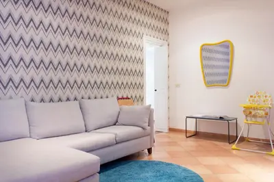 a living room with a couch and a mirror at TrastevereHome - Vespucci Rome Testaccio Home in Rome