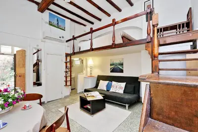 a living room with a loft bed and a couch at Pretty Flat Trastevere in Rome