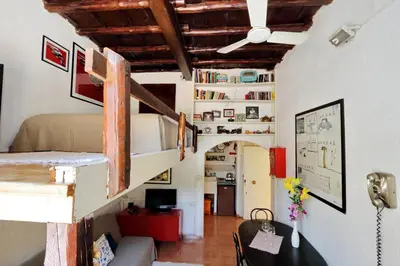 a room with a bunk bed and a living room at Pretty Flat Trastevere in Rome