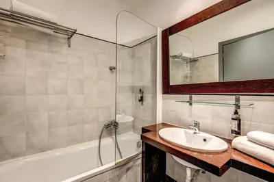 a bathroom with a sink and a shower and a tub at Hotel Giuggioli in Rome
