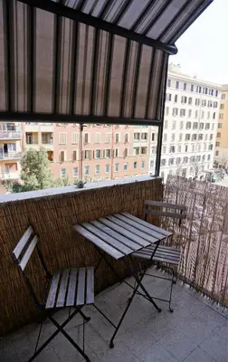 a picnic table and a bench on a balcony at Rhome Away Marconi in Rome