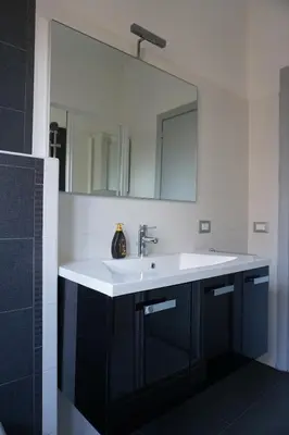 a bathroom with a white sink and a mirror at Rhome Away Marconi in Rome