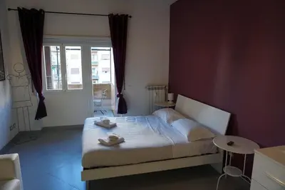 a bedroom with a bed with two towels on it at Rhome Away Marconi in Rome
