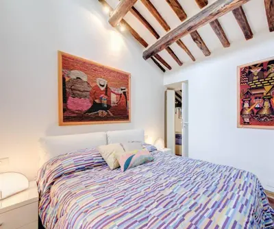 a bedroom with a bed and a painting on the wall at Appartamento Piazza del parlamento 3 in Rome