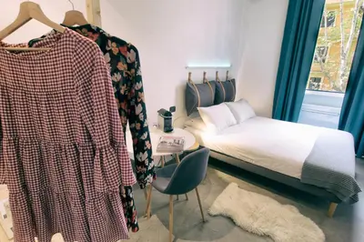 a bedroom with a bed and a chair and a table at Santa Nara B&B in Rome