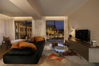 a living room with a couch and a tv at Hotel Palazzo Manfredi – Small Luxury Hotels of the World in Rome