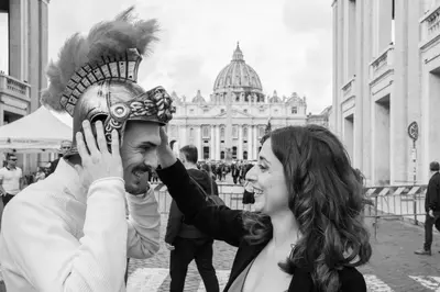 a woman standing next to a man wearing a mask at Vatican Relais Rome Suite in Rome