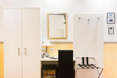 a room with a desk with a chair and a mirror at Domus Popolo in Rome