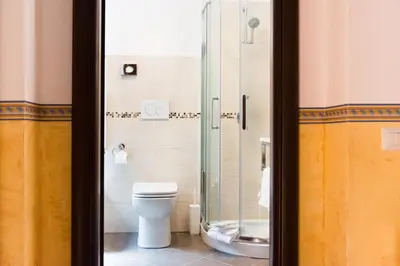 a bathroom with a toilet and a glass shower at Domus Popolo in Rome