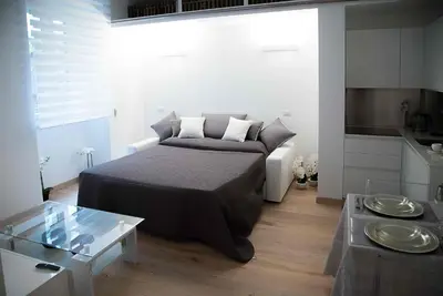 a small bedroom with a bed and a table at Relais Dolcevita in Rome