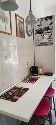 a kitchen with a white counter with two stools at Valentina Vatican Apartment in Rome