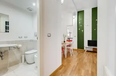 a bathroom with a toilet and a sink and a table at San Cosimato House in Rome