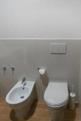 a bathroom with a white toilet and a sink at Flaminio New Apartment in Rome