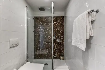a bathroom with a shower and a toilet at Guest House Cavour 278 in Rome