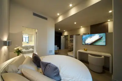 a person sitting on a couch in a living room at BeSecret Vittoriano - Vittoriano Luxury Suites in Rome