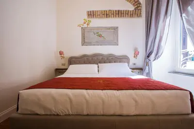 a bedroom with a large bed with a red blanket at Trastevere Royal Suite in Rome