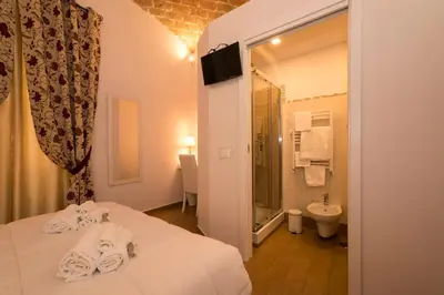 a hotel room with a bed and a bathroom at Fabiola's Home in Rome