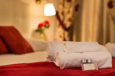 a pile of towels sitting on top of a bed at Fabiola's Home in Rome