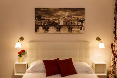 a bedroom with a bed and a painting on the wall at Fabiola's Home in Rome