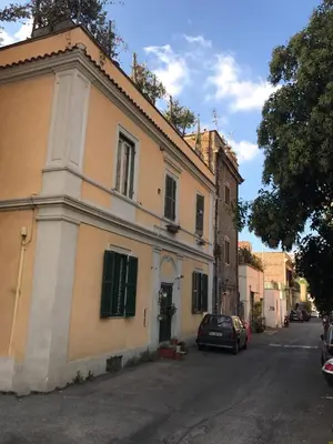 a building with a car parked in front of it at Attico incantevole, Pìgneto Roma in Rome