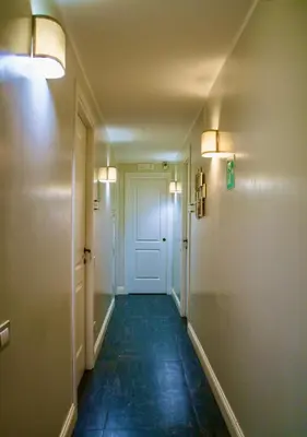 a hallway with a white door and a blue floor at Residenza Roma Imperiale in Rome