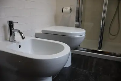 a bathroom with a toilet and a sink and a shower at Residenza Roma Imperiale in Rome